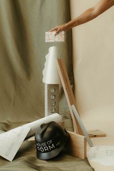 a helmet sitting on top of a table next to a piece of paper and a pair of scissors