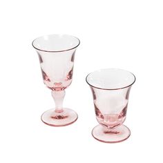 two pink glass vases sitting next to each other