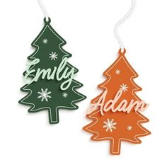 two wooden christmas trees with the words family and adorn on each ornament