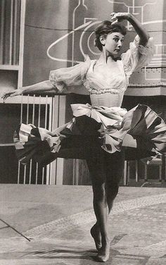 a black and white photo of a ballerina in the middle of her dance moves