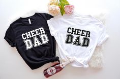 Cheer Dad T-Shirt | Cheerleading Dad Tee | Cheer Dad Apparel | Proud Cheer Dad Shirt | Father's Day Gift | Cheer Squad Dad Graphic Tee Our T-Shirts About our Shirts 1- Non-Heather T-Shirts are %100 cotton 2- Heather T-Shirts are %52 cotton %48 polyester 3- Shirts prints are making with high quality items About Size 1- To make sure about what size fits to you should look at the size chart 2- Our t-shirts fits unisex sizing 3- We have 7 size options and they are XS, S, M, L, XL, 2XL, 3XL Our Policy 1- We produce the shirts within 1- 3 days after get your order 2- Shipping process changes according to your choice 3- Priority shipping provide 2-3 business day shipping 4- First Class shipping provide 1-5 business day shipping About Order 1- Firstly, choose a size 2- Then, choose a primarily col White T-shirt With Text Print For Cheerleading, Cheer Dad Shirt, Cheer Dad Shirts, Cheer Squad, Dad To Be Shirts, Cheerleading, Father's Day, Printed Shirts, Graphic Tee