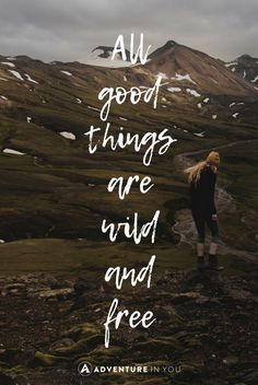 a woman standing on top of a mountain with the words all good things are wild and free