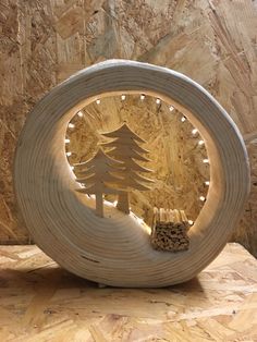 a wooden clock with a pine tree cut out of it