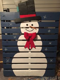 a wooden pallet with a snowman on it