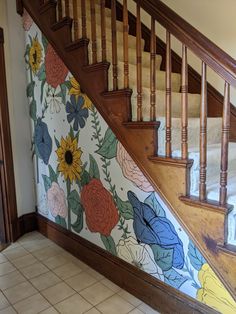 the stairs are decorated with colorful flowers and wooden railings, along with tile flooring