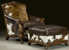 an old chair and ottoman with cow hide