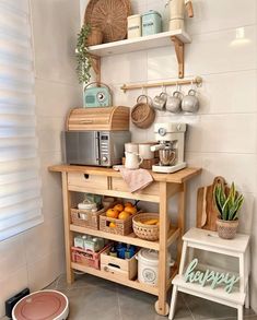 a kitchen area with shelves, coffee maker and other items on the counter in front of it