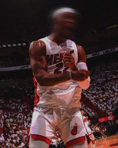 a basketball player is standing on the court