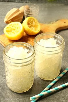 two mason jars filled with sugar and lemons next to chopsticks on a cutting board