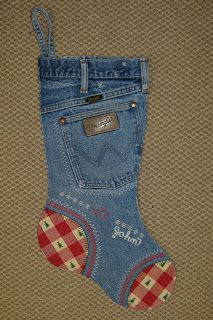 a pair of blue jeans with red and white checkered socks on them, sitting next to each other