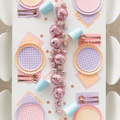 the table is set with plates, napkins and other decorations for a baby's first birthday party