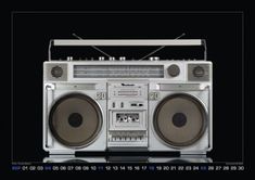 an old fashioned boombox with speakers on it's front and back sides, against a black background