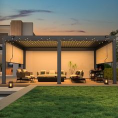 an outdoor living area with couches, tables and lights on the patio at dusk