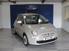 a small white car parked in a garage