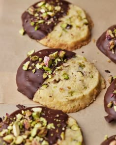 chocolate covered cookies with nuts and pistachios on top