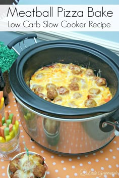 a crock pot filled with food sitting on top of a table next to candy