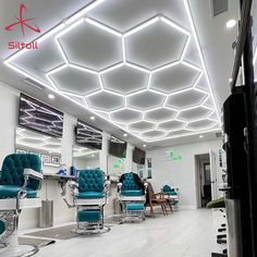 the interior of a hair salon with blue chairs