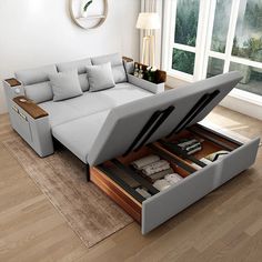 a living room with a couch that is open to reveal a bed underneath the sofa