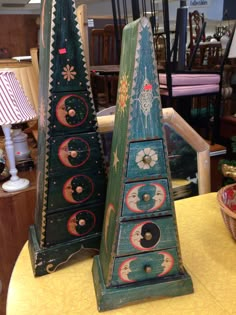 two wooden clocks sitting on top of a table