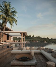 a couch sitting on top of a wooden deck next to a lake