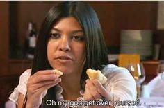 a woman sitting at a table eating food