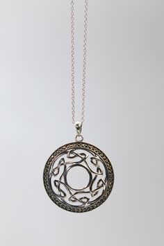 Crafted in Dublin, Ireland, interlaced sterling silver forms a contemporary open Celtic knot, surrounded by a halo of handset marcasite stones Cast in .925 silver, it is hand polished to perfection. Chain Length 18" Pendant 1.2" Diameter .925 Silver, Marcasite Cable Link Chain Made In Ireland Ships from the USA Why we love this product? Holding this jewelry, you can quickly understand the inspiration behind this artists designs. Taking inspiration from his Celtic heritage, his jewelry is light, Ornate Sterling Silver Medallion Jewelry, Silver Oxidized Marcasite Jewelry, Antique Marcasite Round Jewelry, Celtic Heritage, Celtic Pendant, Marcasite Jewelry, Celtic Necklace, Portfolio Ideas, Irish Celtic