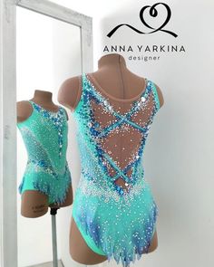 a mannequin wearing a blue and white leotard with sequins