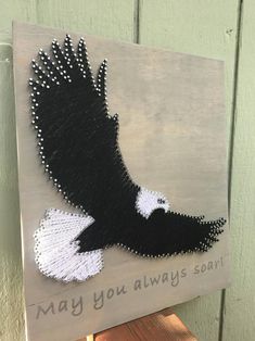 a sign with an eagle painted on it that says may you always sort