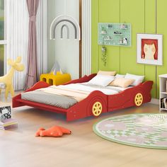 a child's bedroom with green walls and white furniture, including a red car bed