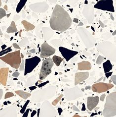 a white and black floor with various colored rocks