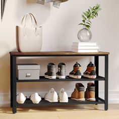 there is a shelf with many pairs of shoes on it next to a plant and purse