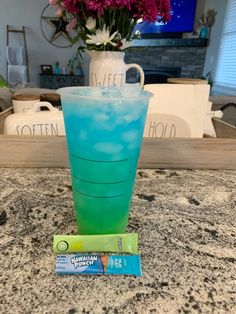 a blue drink sitting on top of a counter next to a tube of toothpaste