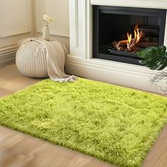 a living room with a fireplace and green rug