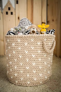 a knitted basket with stuffed animals in it