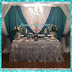 a table topped with lots of cake next to a chandelier