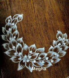 a drawing of a flower on a wooden surface with the words megha written below it