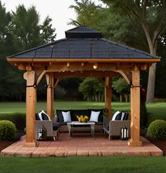 a wooden gazebo sitting on top of a lush green field