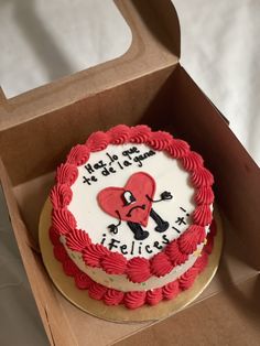 a red and white cake in a box