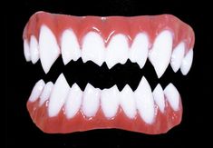 an open mouth with white teeth on a black background