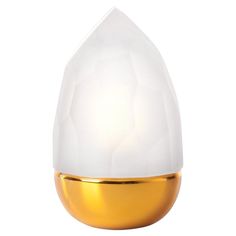 a white and gold egg shaped lamp on a white background