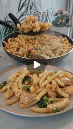 two pans filled with pasta and broccoli sitting on top of a table