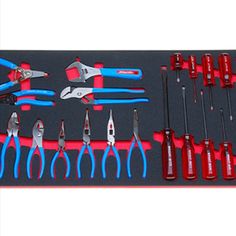 tools are laid out on a table with red and blue trimmings in them