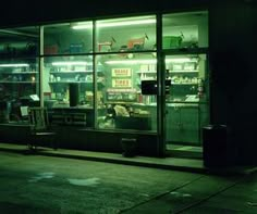 an empty store front at night with the lights on