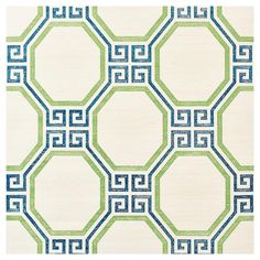 a green and blue rug with geometric designs