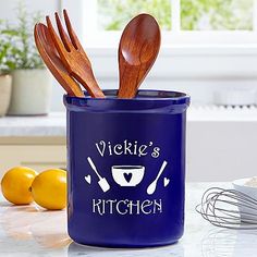 a blue kitchen canister with wooden spoons and utensils