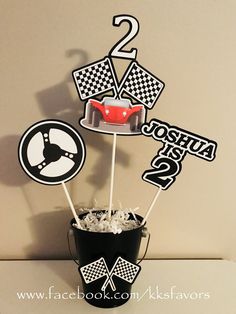 a birthday cake topper sitting on top of a bucket