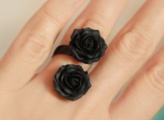 Double Floral ring with two matt black roses . Material of roses- polymer clay. Each petal made by hand. Adjustable base ring in black color about 6-8.5 us/ 16.5-18.5 mm/ 53-59 eur Base of ring is metal Size of flower about 18*18mm/ 0.7 inch DOUBLE RING WITH 2 MATT BLACK ROSES AND STAINLESS STEEL BASE - https://www.etsy.com/listing/957711501 DOUBLE RING WITH 2  BLACK PEARL ROSES AND STAINLESS STEEL BASE - https://www.etsy.com/listing/938930722 BLACK ROSE RING-  https://www.etsy.com/listing/633504133/black-rose-ring-silver-base-ring-polymer?ref=shop_home_active_4&pro=1      Black flowers set jewellery - https://www.etsy.com/listing/740056189/black-flowers-set-jewellery-polymer-clay?ref=shop_home_active_1       Black orchids necklace - https://www.etsy.com/listing/498453721/black-orchids-nec Black Clay Rings, Clay Finger Ring, Black Flower-shaped Rings For Gifts, Black Flower Shaped Rings For Gift, Black Flower Shaped Ring For Gifts, Polymer Rings, Fimo Ring, Black Rose Ring, Unique Ring Box