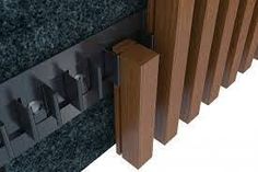 a close up of a wooden radiator on a wall with black granite and wood slats