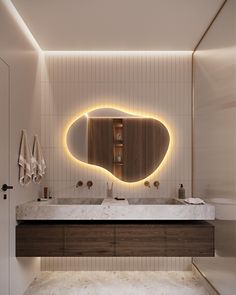 a bathroom with a sink, mirror and lights on the wall above it's counter