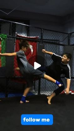 two young boys practicing martial moves in a caged - in area with the caption follow me